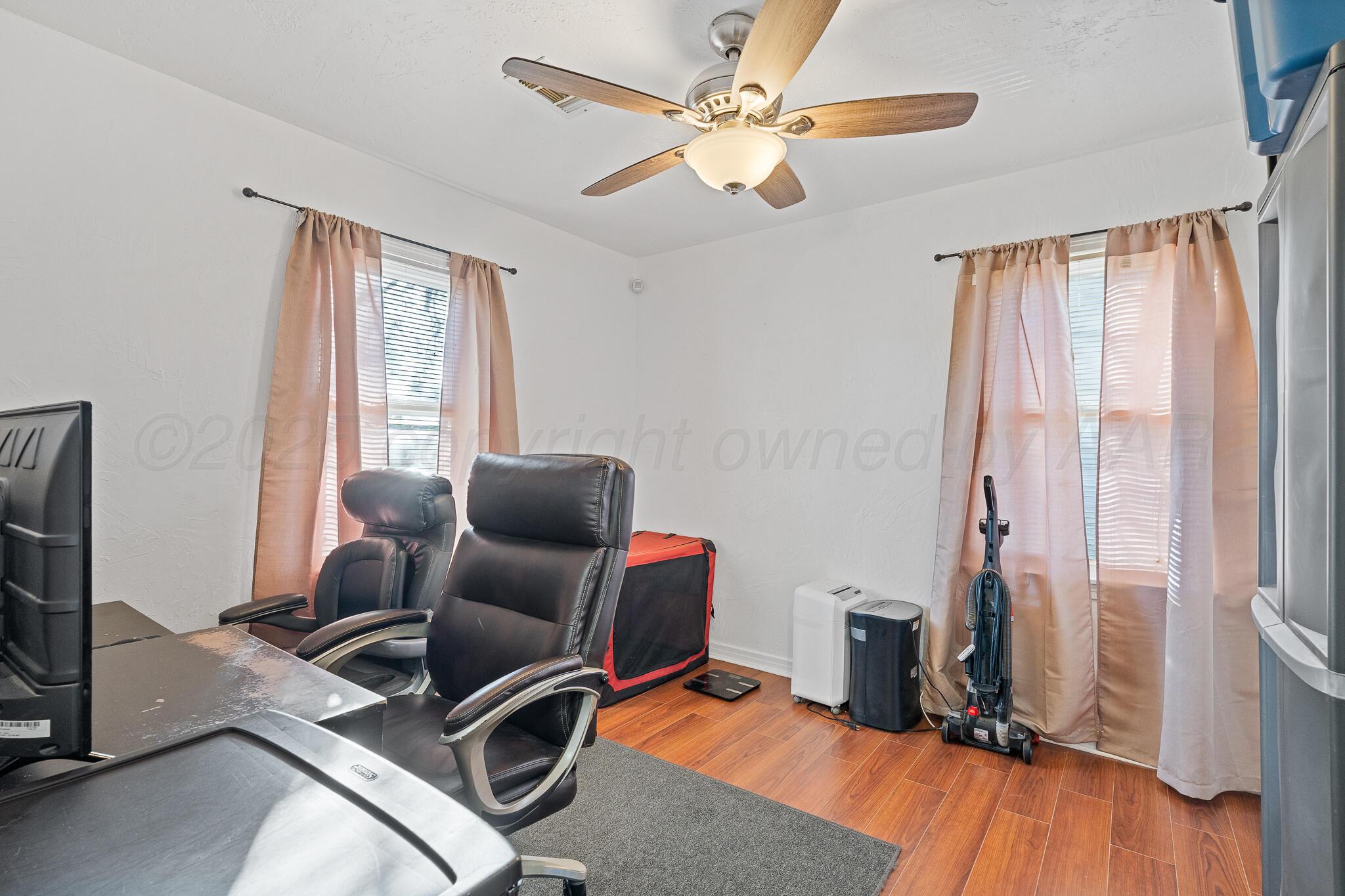 4105 Parker Street Amarillo, TX 79110 - Photo 8 of 10 a room with furniture and wooden floor