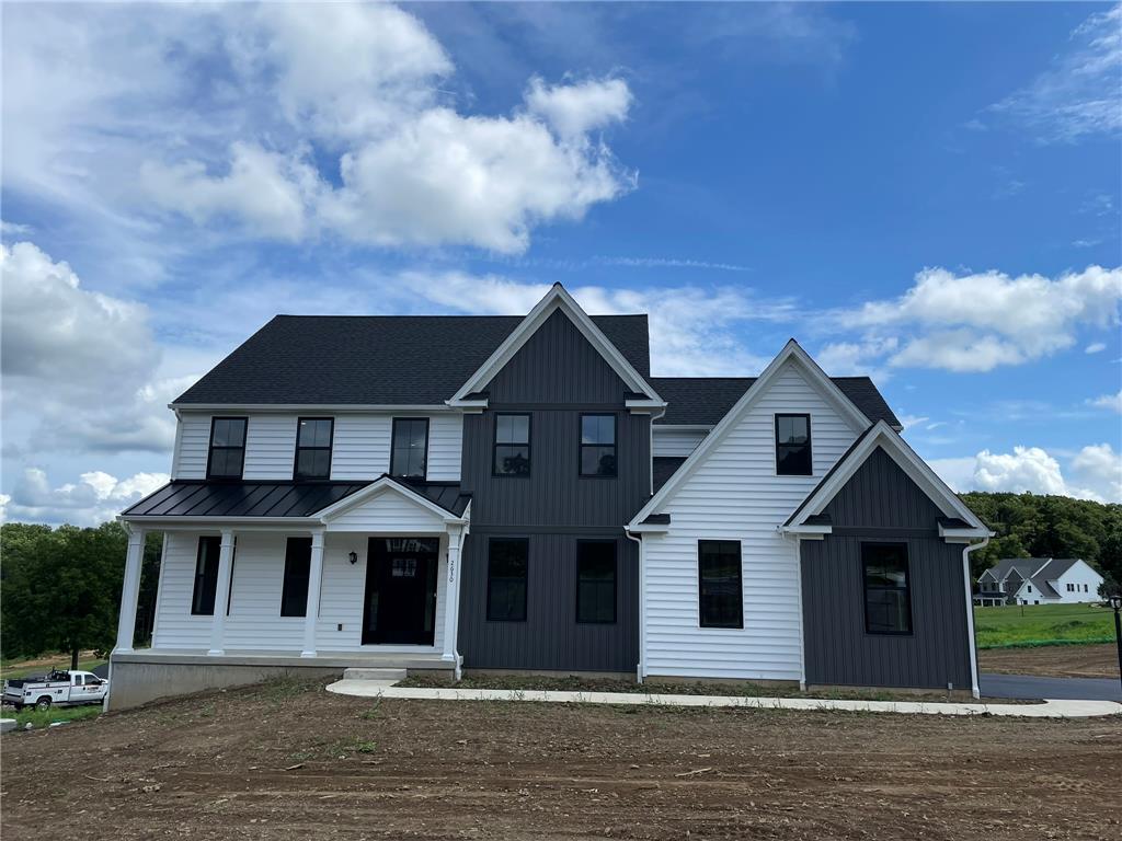 5043 Chapmans Road Orefield, PA 18069 - Photo 1 of 30 Bold modern architecture blends white siding with dark vertical accents, crowned by a sleek black roof.