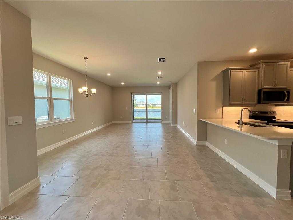 842 Enbrook Loop Naples, FL 34114 - Photo 4 of 23 a view of a kitchen with a sink and a window