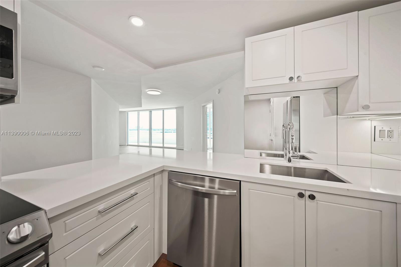 555 Northeast 34th Street, Unit 2307 Miami, FL 33137 - Photo 11 of 63 a kitchen with a sink and cabinets