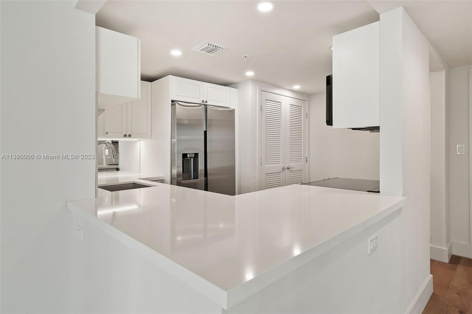 555 Northeast 34th Street, Unit 2307 Miami, FL 33137 - Photo 12 of 63 a bathroom with a sink a faucet a mirror and a shower