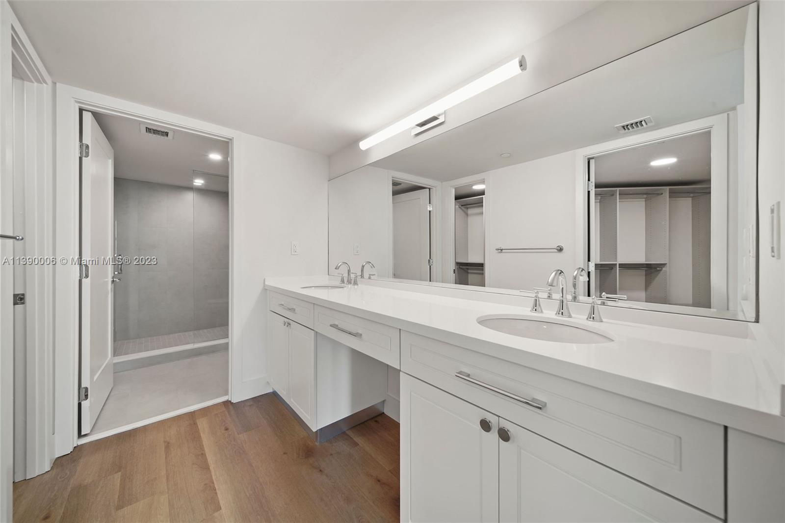 555 Northeast 34th Street, Unit 2307 Miami, FL 33137 - Photo 25 of 63 a bathroom with a sink and a mirror