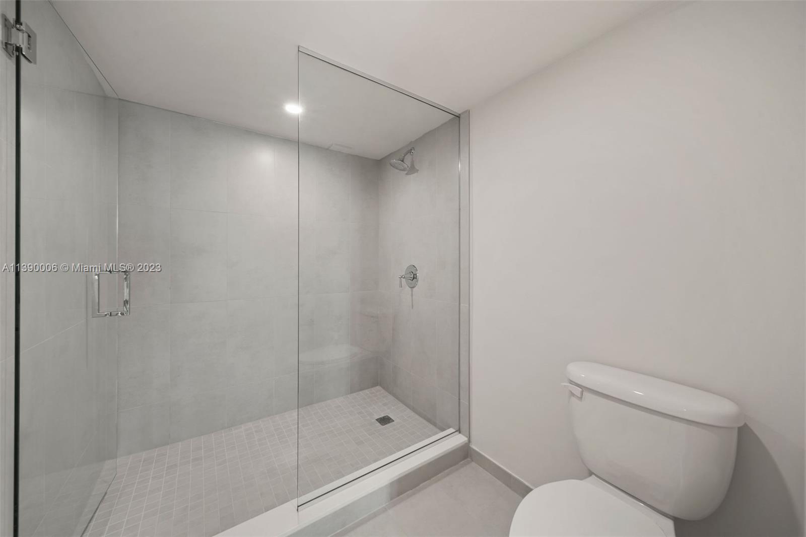 555 Northeast 34th Street, Unit 2307 Miami, FL 33137 - Photo 29 of 63 a bathroom with a toilet and shower