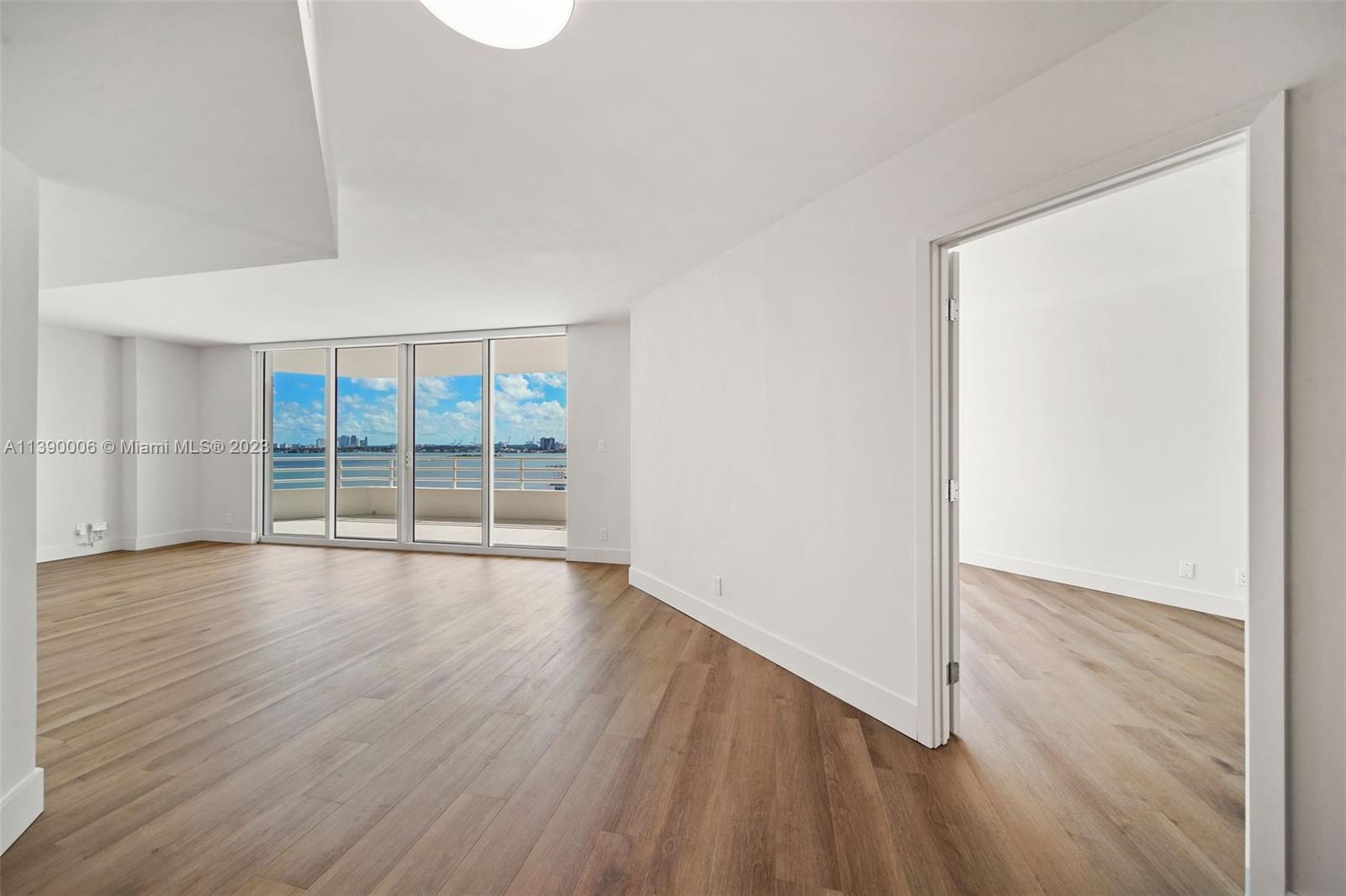 555 Northeast 34th Street, Unit 2307 Miami, FL 33137 - Photo 3 of 63 an empty room with wooden floor and windows