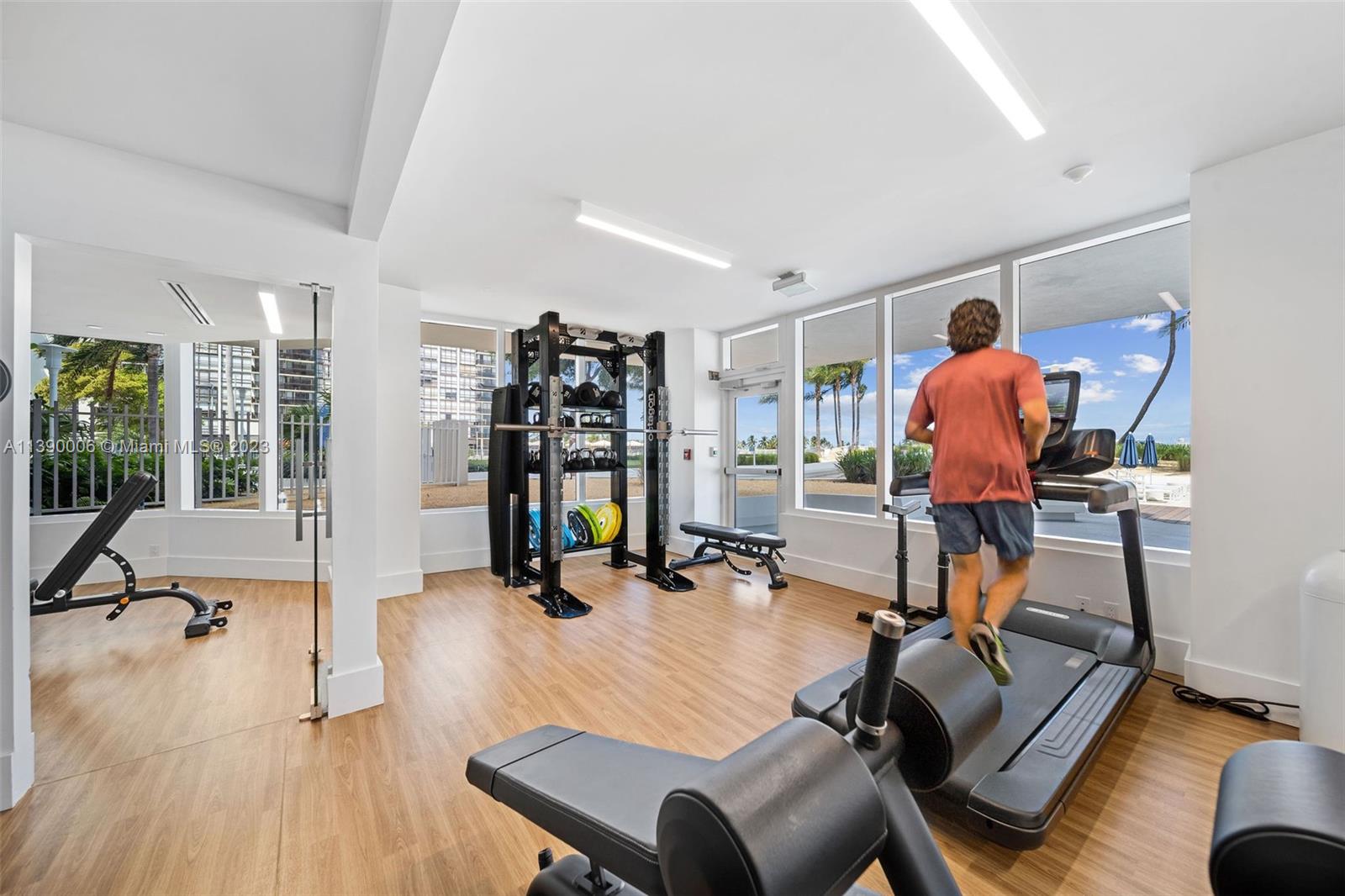 555 Northeast 34th Street, Unit 2307 Miami, FL 33137 - Photo 45 of 63 a room with gym equipment and a view of living room