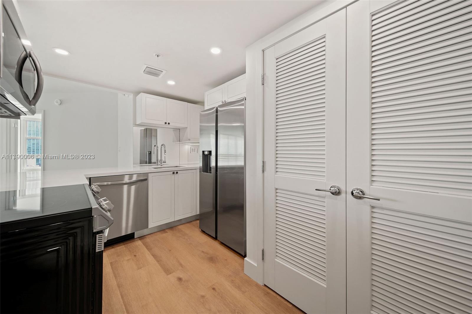 555 Northeast 34th Street, Unit 2307 Miami, FL 33137 - Photo 8 of 63 a kitchen with a refrigerator and a sink