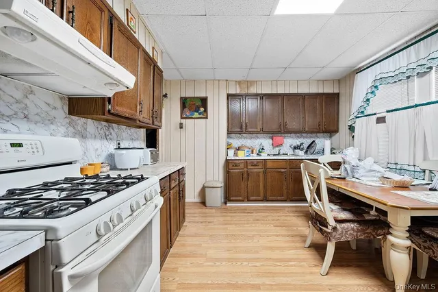 a kitchen with kitchen island a stove a sink and a refrigerator