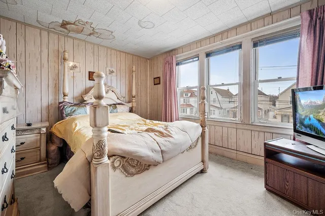 a bed sitting in a room next to a window