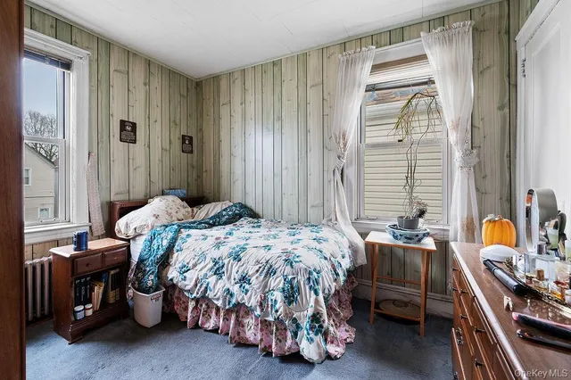 a bedroom with bed and a window