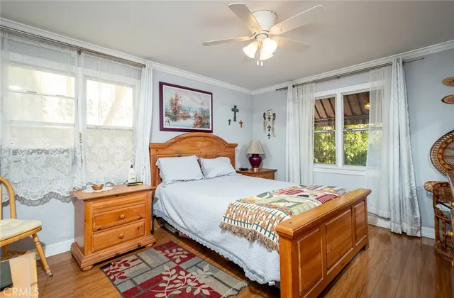 a bedroom with a bed and a window with the outer view