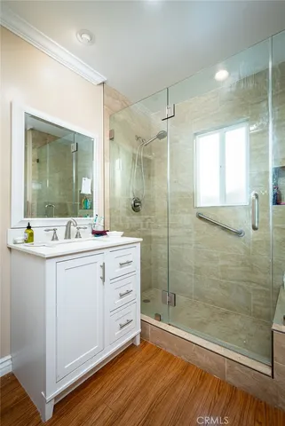 a bathroom with a double vanity sink mirror and shower