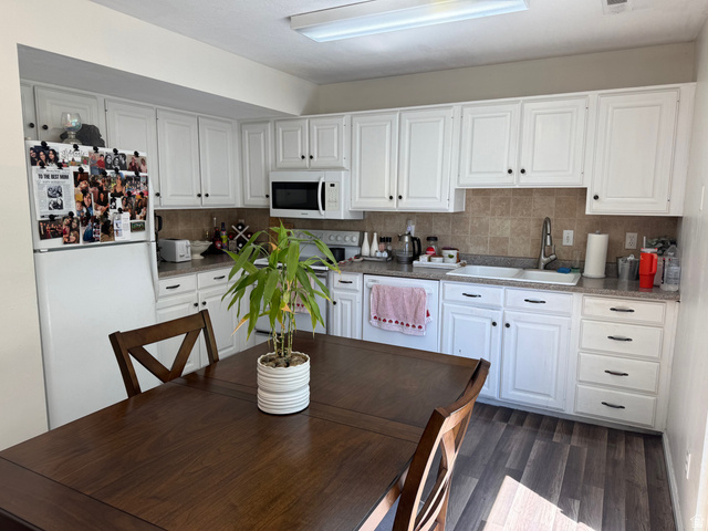 183 East 820 South Centerville, UT 84014 - Photo 4 of 14 Kitchen featuring white cabinetry, a tiled backsplash, and wood-finish flooring