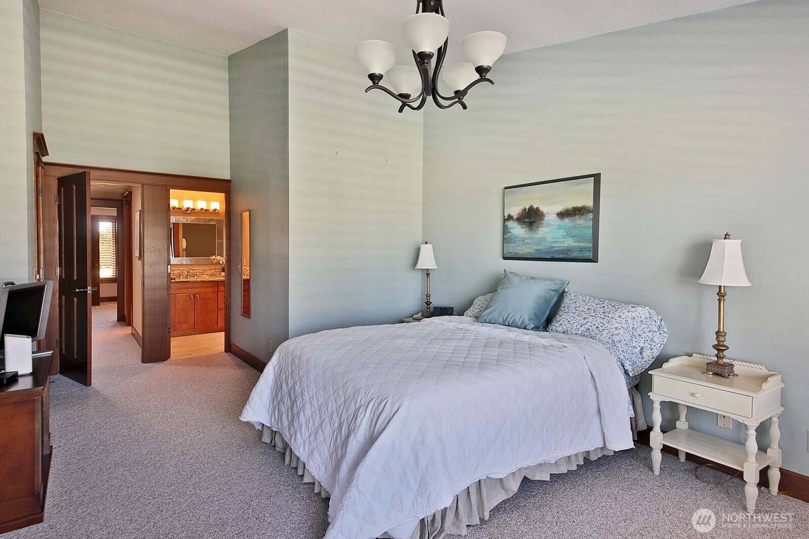 2471 Soundview Drive Langley, WA 98260 - Photo 13 of 38 a bedroom with a bed and a chandelier