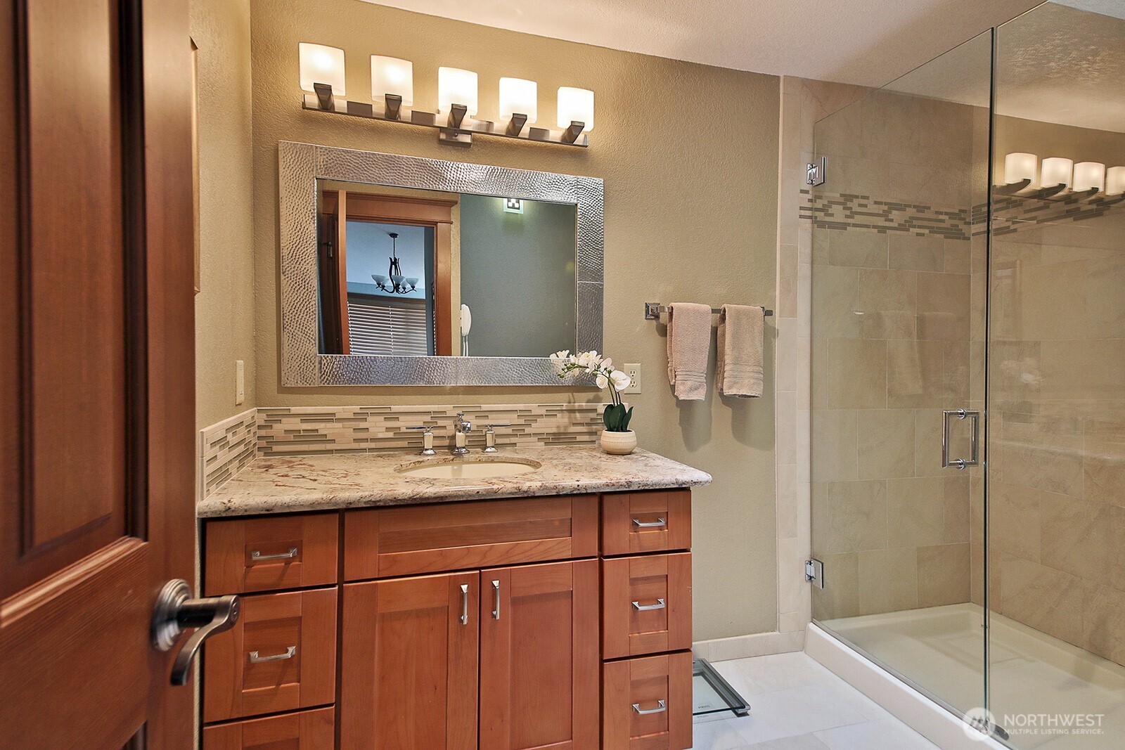 2471 Soundview Drive Langley, WA 98260 - Photo 15 of 38 a bathroom with a granite countertop sink a mirror and shower