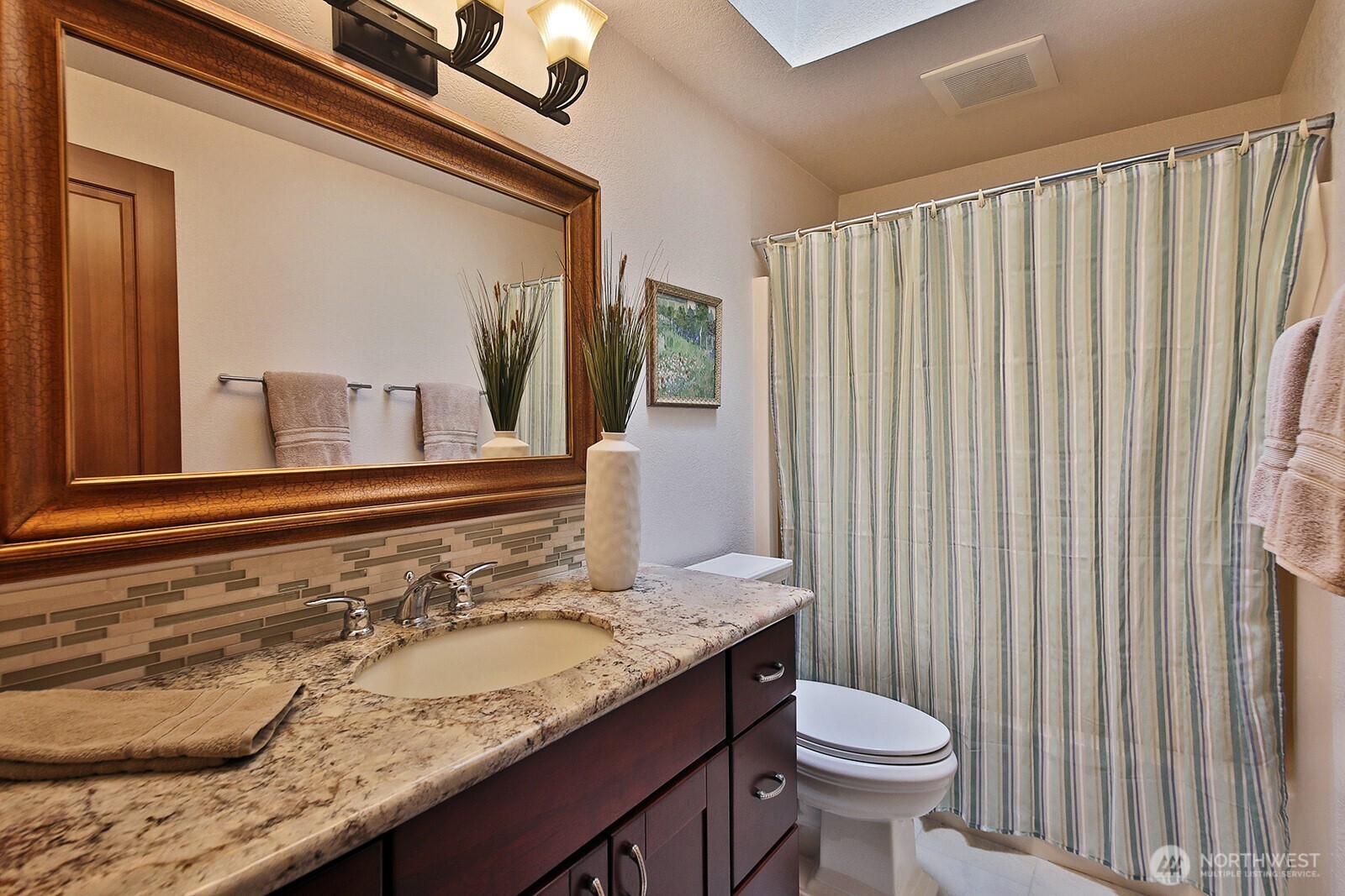 2471 Soundview Drive Langley, WA 98260 - Photo 21 of 38 a bathroom with a granite countertop sink and a toilet