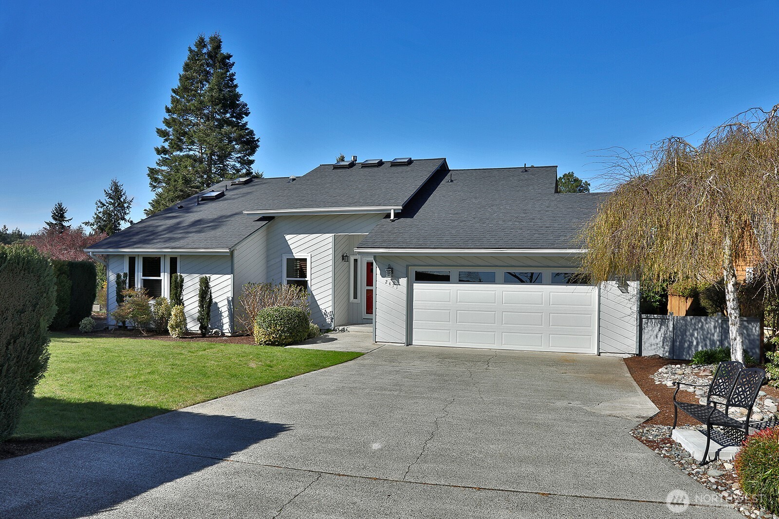 2471 Soundview Drive Langley, WA 98260 - Photo 22 of 38 a front view of a house with a yard and garage