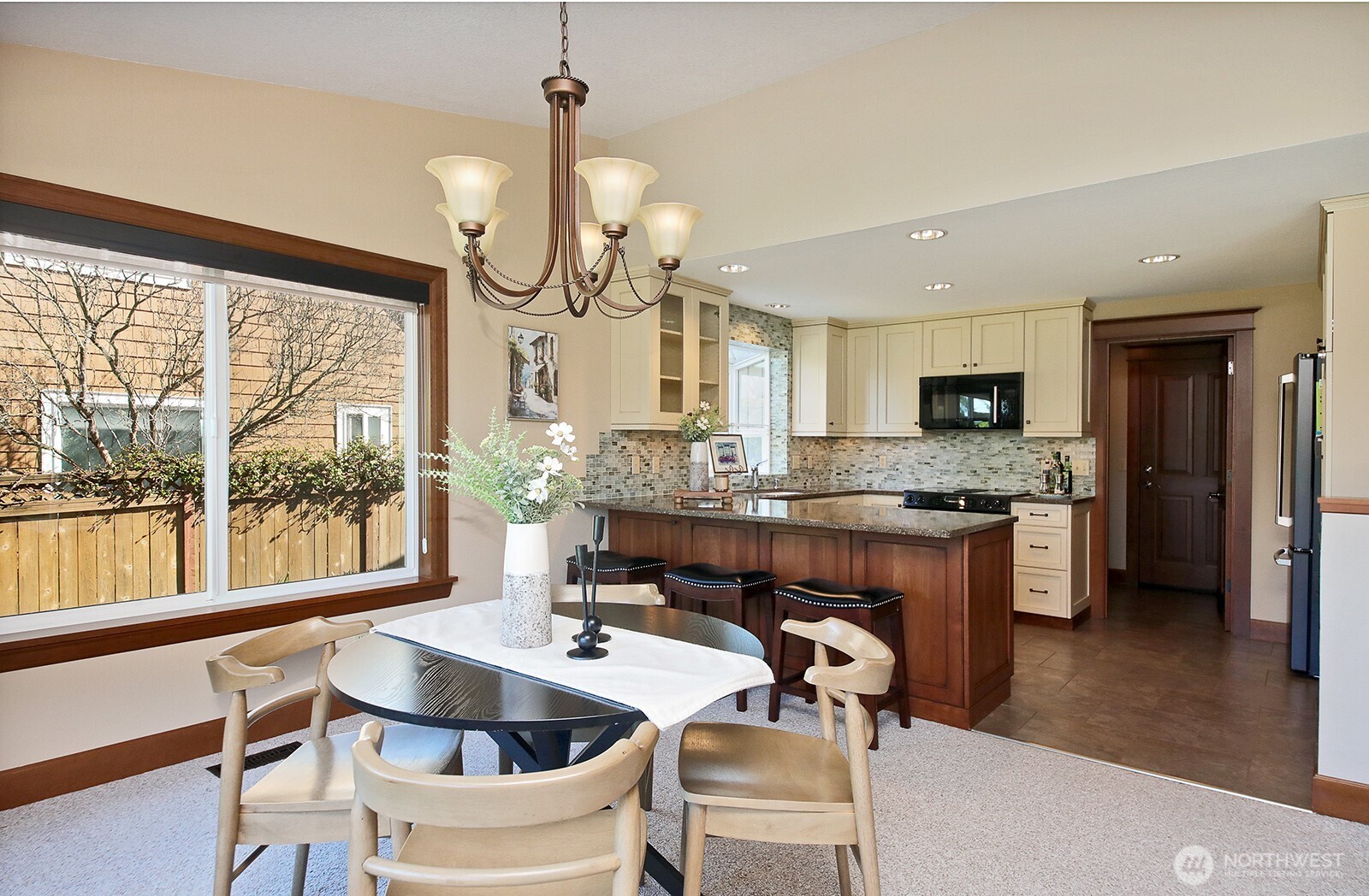 2471 Soundview Drive Langley, WA 98260 - Photo 7 of 38 a kitchen with a table chairs stove and wooden floor
