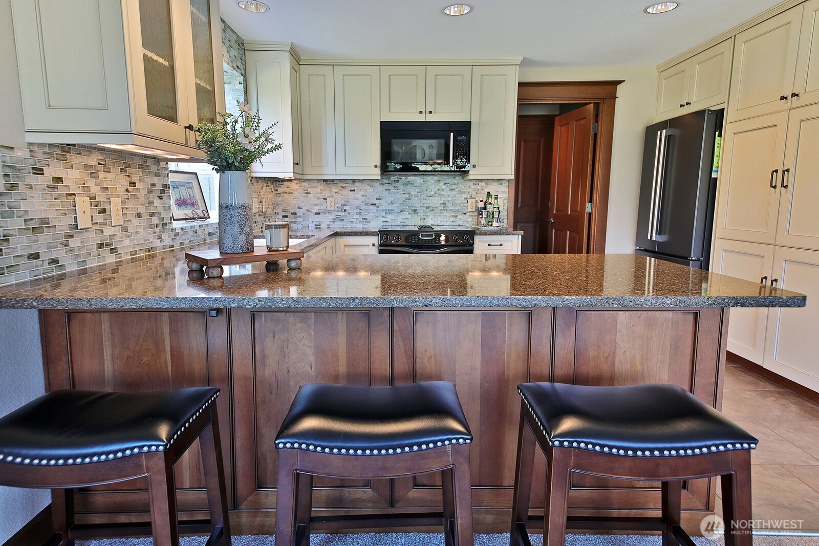 2471 Soundview Drive Langley, WA 98260 - Photo 8 of 38 a kitchen with a chair and a stove