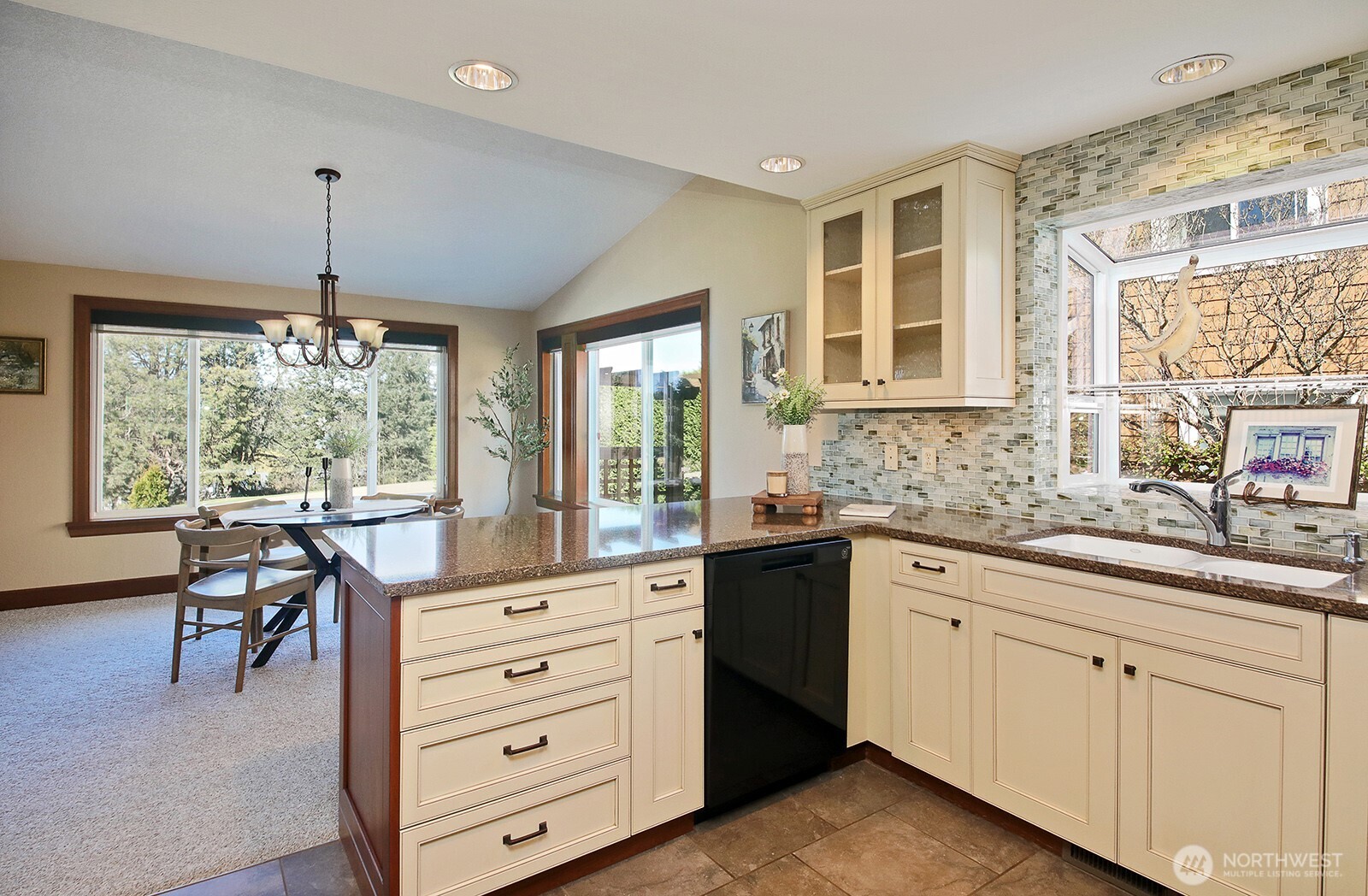 2471 Soundview Drive Langley, WA 98260 - Photo 10 of 38 a kitchen that has white cabinets a table and chairs in it