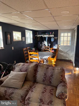 a living room with furniture a flat screen tv and a window