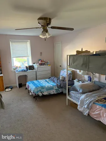 a bedroom with bed and window