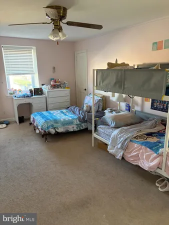a bedroom with bed and window