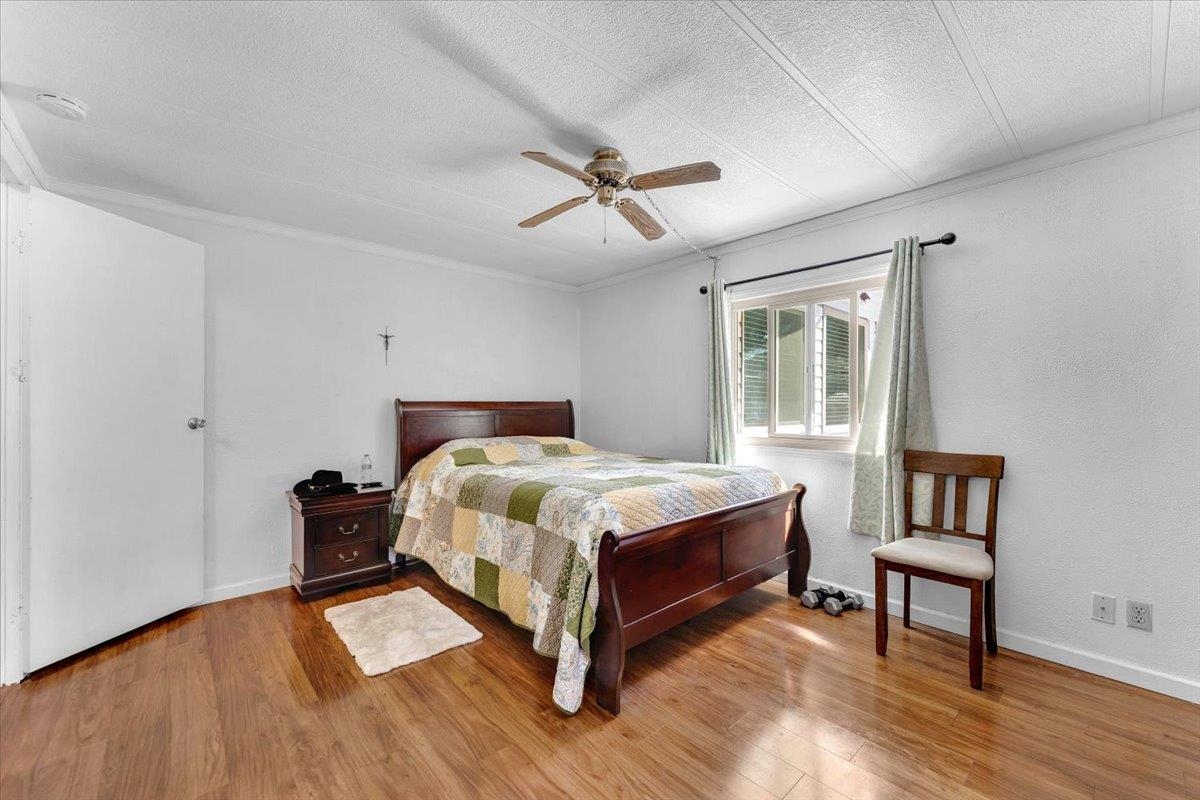 350 Gilmore Road Red Bluff, CA 96080 - Photo 16 of 27 a bedroom with a bed and wooden floor