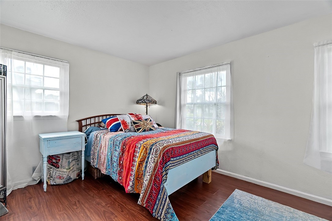 481 Warren Street Sebastian, FL 32958 - Photo 20 of 33 a bed sitting in a bedroom next to a window