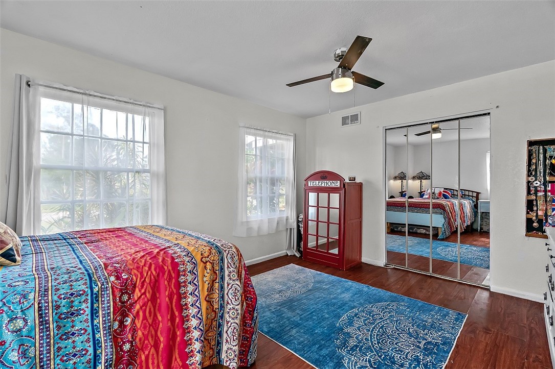 481 Warren Street Sebastian, FL 32958 - Photo 22 of 33 a bedroom with a bed a dresser and wooden floor