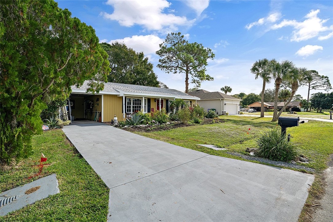 481 Warren Street Sebastian, FL 32958 - Photo 33 of 33 a front view of a house with a yard and trees