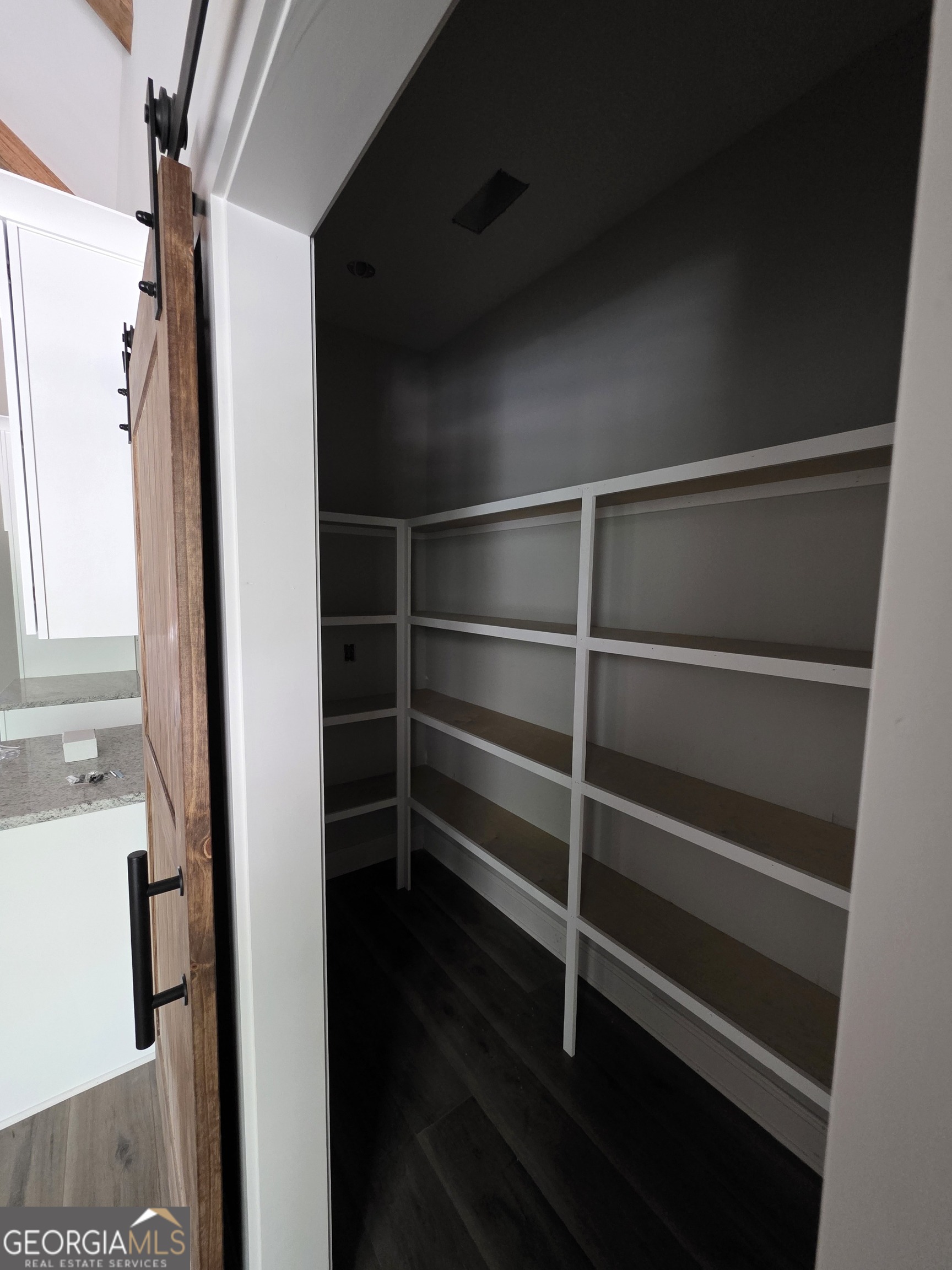 215 Panola Road Jackson, GA 30233 - Photo 7 of 16 a view of walk in closet with wooden floor and windows