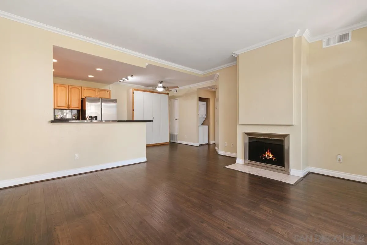 4049 Carmel View Road, Unit 75 San Diego, CA 92130 - Photo 3 of 13 a view of a livingroom with wooden floor and a fireplace