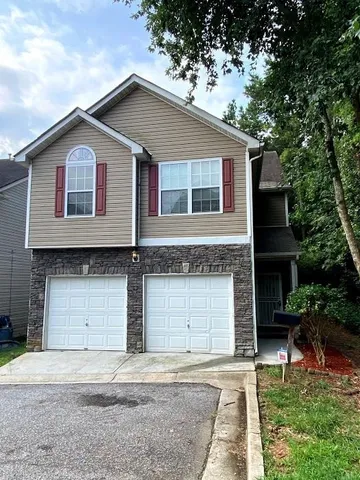 a front view of a house with a garage