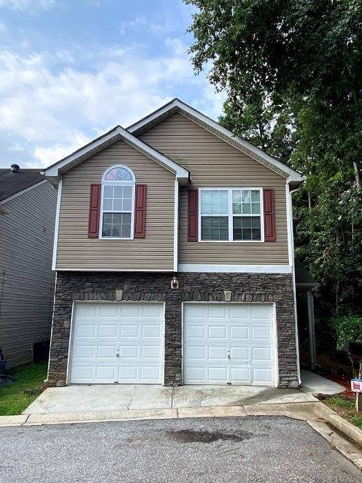 1630 Tigris Court Atlanta, GA 30349 - Photo 3 of 33 a front view of a house with garage