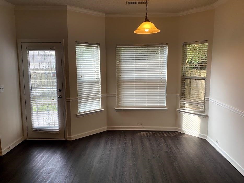 1630 Tigris Court Atlanta, GA 30349 - Photo 8 of 33 a view of an empty room with wooden floor and windows