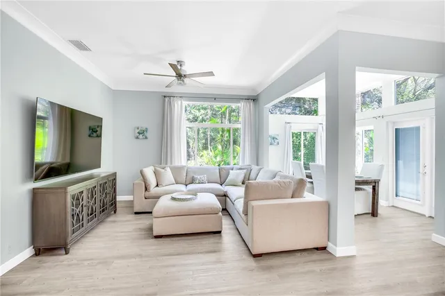 a living room with furniture windows and a flat screen tv
