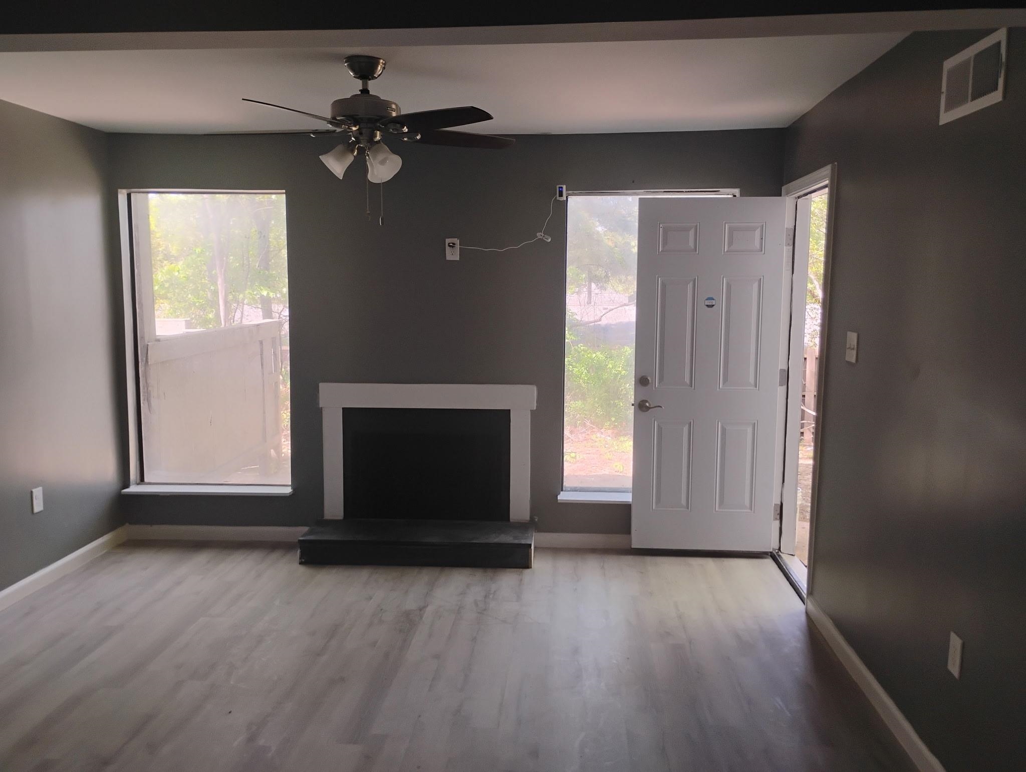 3340 Kirby Trees Place, Unit 3340 Memphis, TN 38115 - Photo 2 of 16 Unfurnished living room with wood finished floors, ceiling fan, and healthy amount of natural light