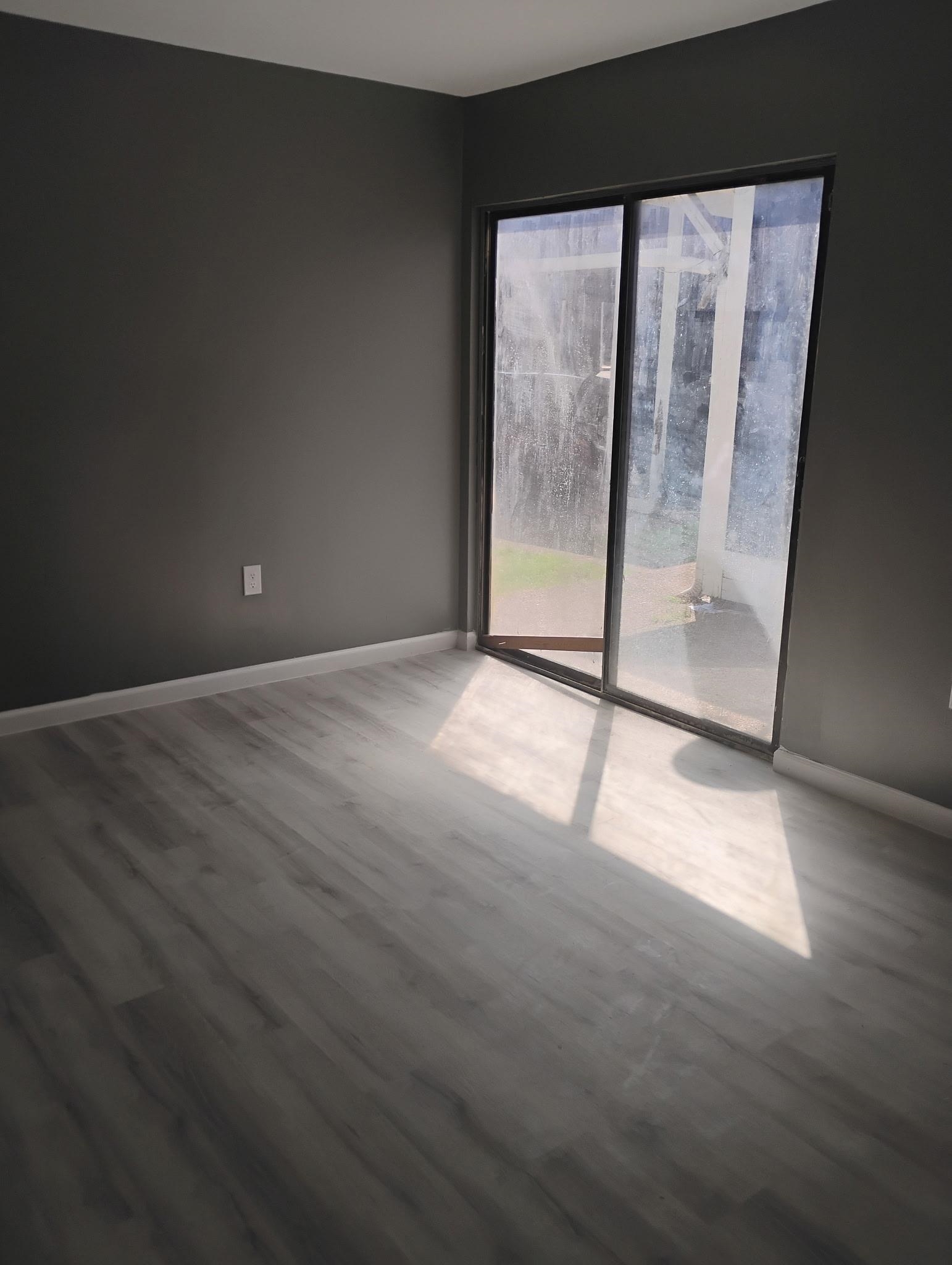 3340 Kirby Trees Place, Unit 3340 Memphis, TN 38115 - Photo 3 of 16 Unfurnished room featuring wood finished floors and baseboards and Sliding Glass Door.