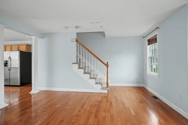 a view of entryway and hall with wooden floor