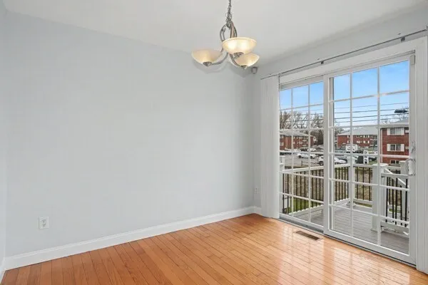 a view of wooden floor and windows in a room