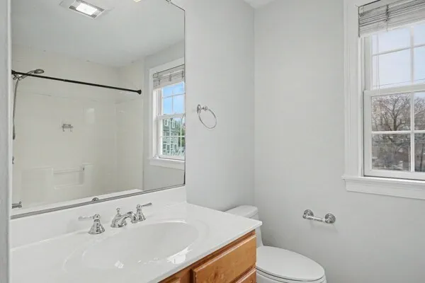 a bathroom with a sink a toilet and shower
