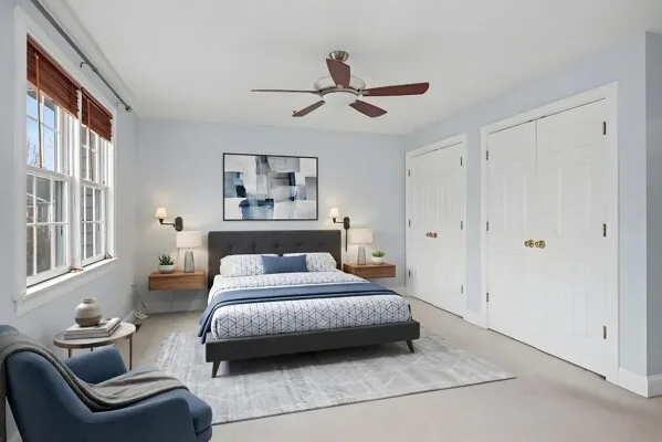 a bedroom with a bed couch and a window
