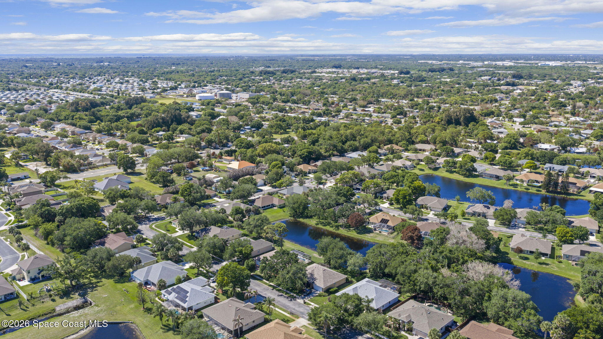1123 Spring Oak Drive Melbourne, FL 32901 - Photo 61 of 67 an aerial view of a city with lots of residential buildings