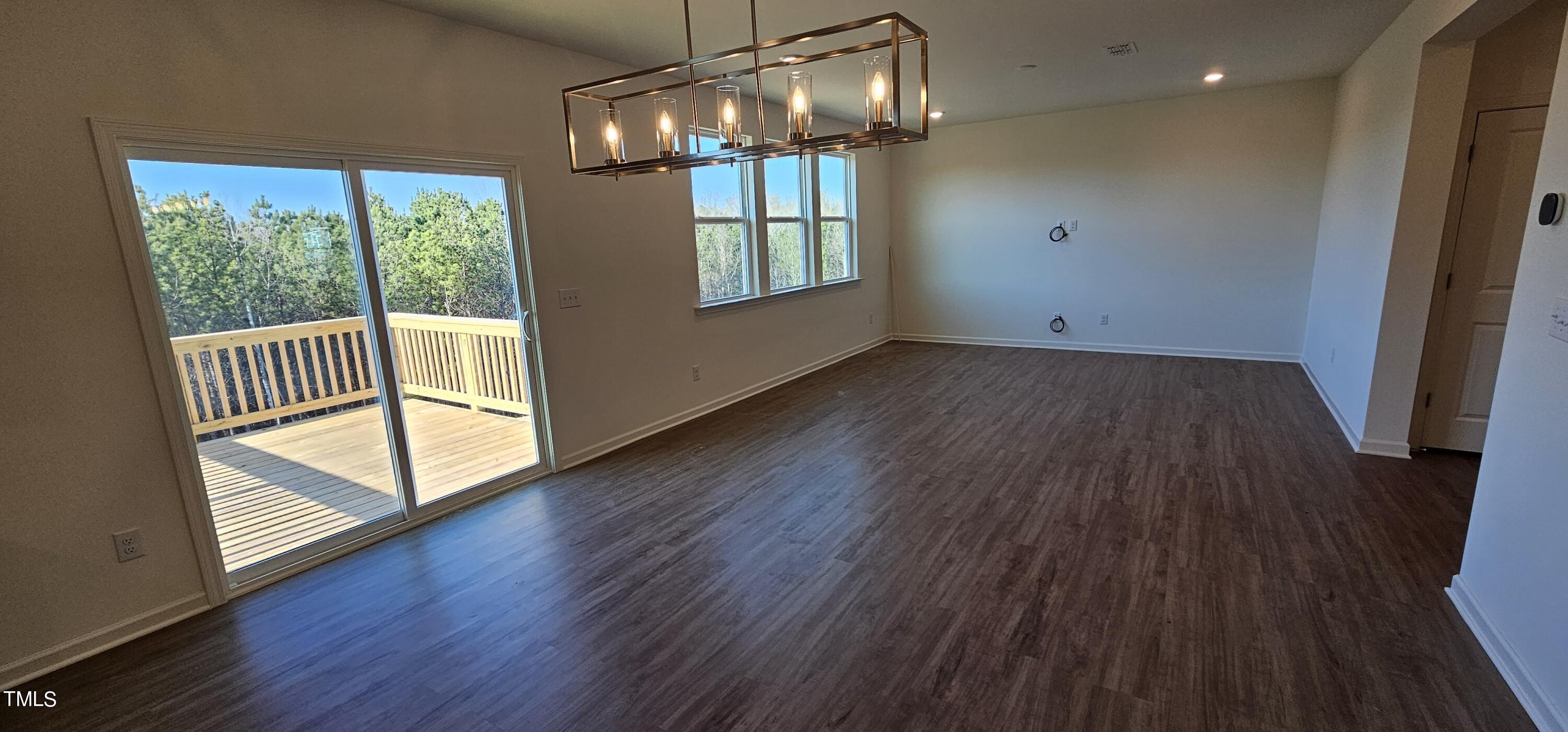 1409 Underbrush Drive Durham, NC 27703 - Photo 4 of 21 a view of empty room with wooden floor and fan