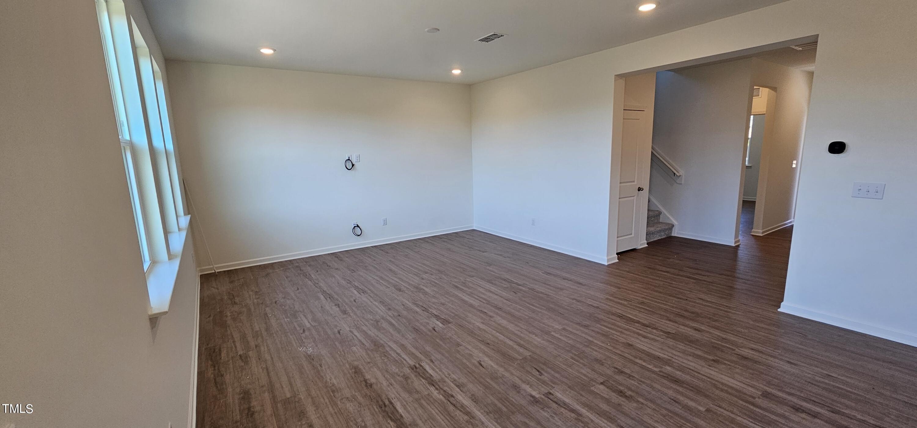 1409 Underbrush Drive Durham, NC 27703 - Photo 5 of 21 an empty room with wooden floor and entrance