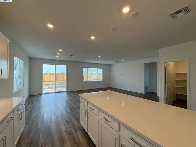 a spacious bathroom with a sink and a large mirror