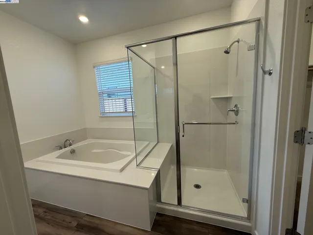 a bathroom with a bathtub and a shower