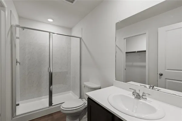 a bathroom with a sink toilet and shower