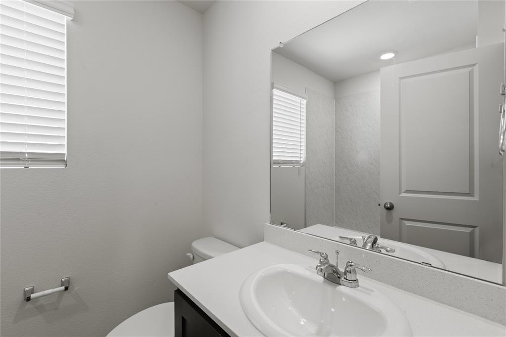 7016 Vining Drive Princeton, TX 75407 - Photo 18 of 22 a bathroom with a sink and a toilet
