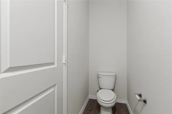 a white toilet sitting next to a shower